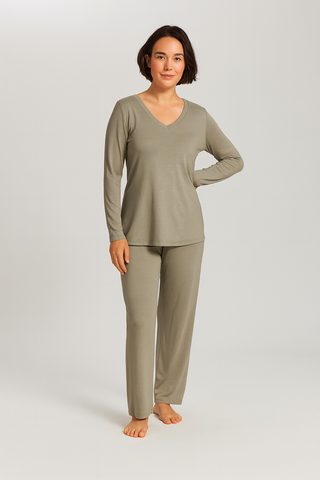 Woman wearing a green pajama set on a white background